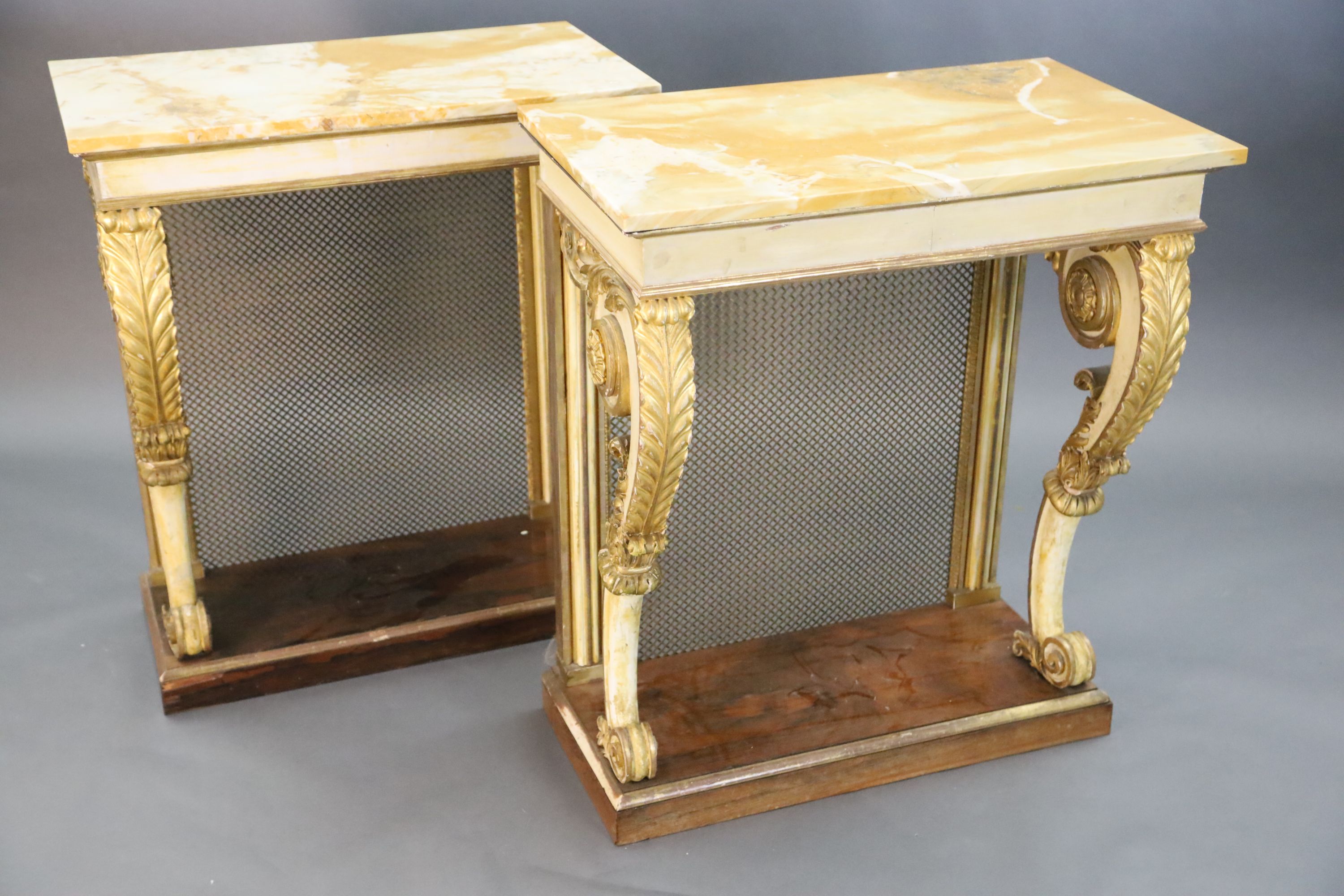A pair of William IV parcel gilt cream painted and rosewood console tables, W.2ft 6in. D.1ft 6.5in. H.2ft 11.5in.